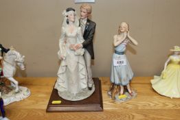 A Belcari figure group of a bride and groom and a