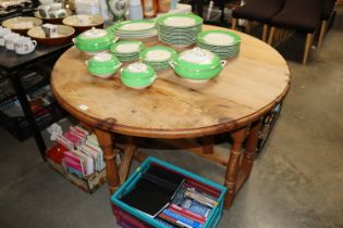 A stripped pine gateleg dining table