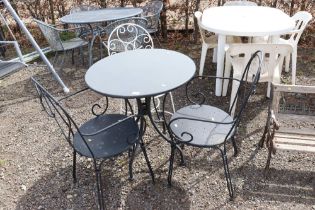 A granite top garden table with three chairs