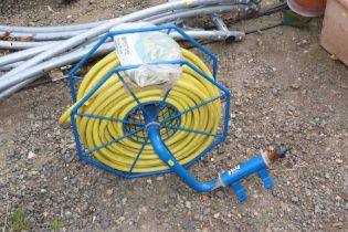 A hose on reel and a hanging basket with liner