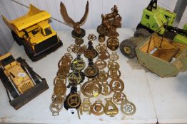 A collection of various horse brasses; a sheep gro