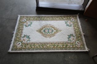 An approx 5' x 3'2" floral patterned rug
