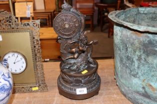 A bronzed mantel clock with cherub decoration