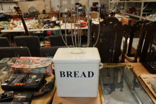 An enamel bread bin and a metal candelabra