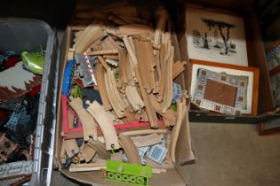 A box of wooden railway track and accessories