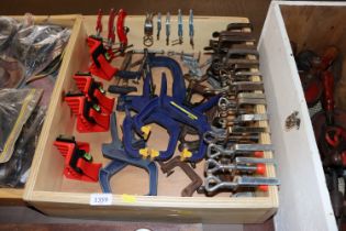 A wooden tray containing various clamps