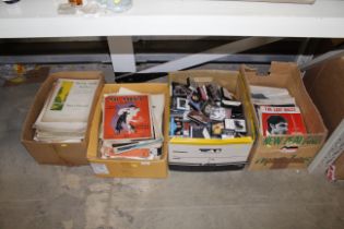 A large collection of various sheet music and cassettes