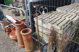 A quantity of garden stakes; two iron candle holders