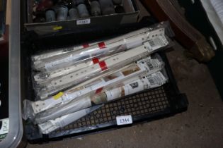 A plastic crate of assorted drawer slides