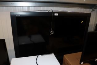 A Sony Bravia flat screen television with remote control