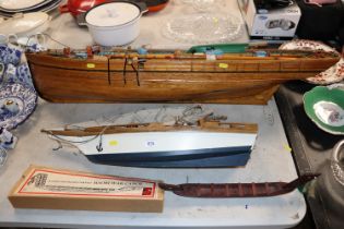 A wooden model of a barge, a model of a sailing sh