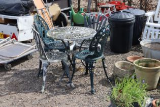 A garden table and two pairs of garden chairs