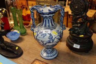 A 19th Century continental pottery twin handled urn with beast decoration and serpent handles