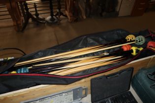 A bag of various snooker cues