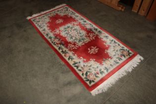 An approx 6'9" x 3' Chinese floral patterned rug