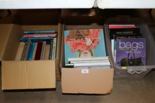 Three boxes containing various fashion books, dres