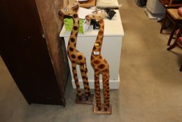 Two wooden giraffe ornaments