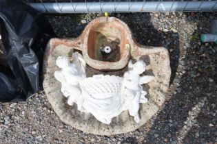 A concrete garden water feature and wall pocket de