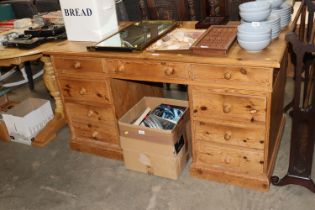 A stripped pine pedestal desk