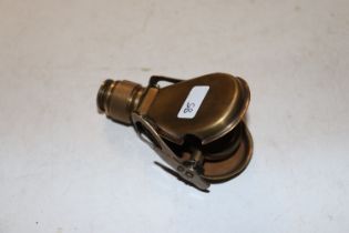 A brass cased folding monocular