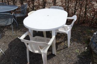 A plastic garden table and four chairs