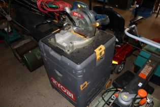 A Ryobi mitre saw with various tools