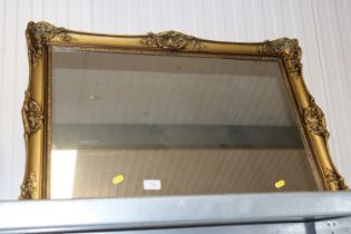 A gilt framed wall mirror