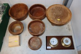 Various turned wooden bowls and a clock and barome