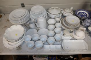 A large quantity of white glazed dinnerware