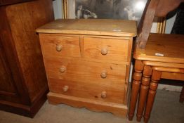 A small stripped pine chest of two short and two l