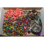 A box of costume jewellery to include bead necklac