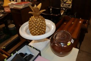 A gilt pineapple ornament; a white glazed comport and a glazed stoneware jar and cover