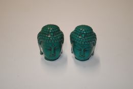 Two simulated turquoise Buddha heads