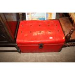 A red painted tin trunk