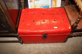 A red painted tin trunk