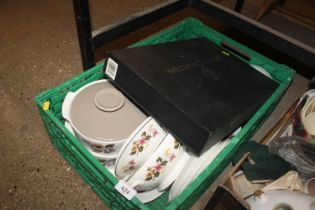 A box of various tea and dinnerware