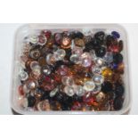 A box of decorative glass pebbles