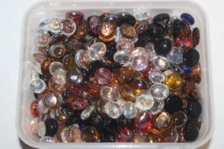 A box of decorative glass pebbles