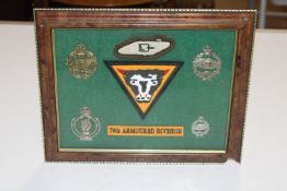 A framed and glazed collection of Royal Armoured Corps badges, 79th Arm Division