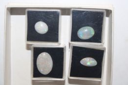 A box containing four pieces of opal