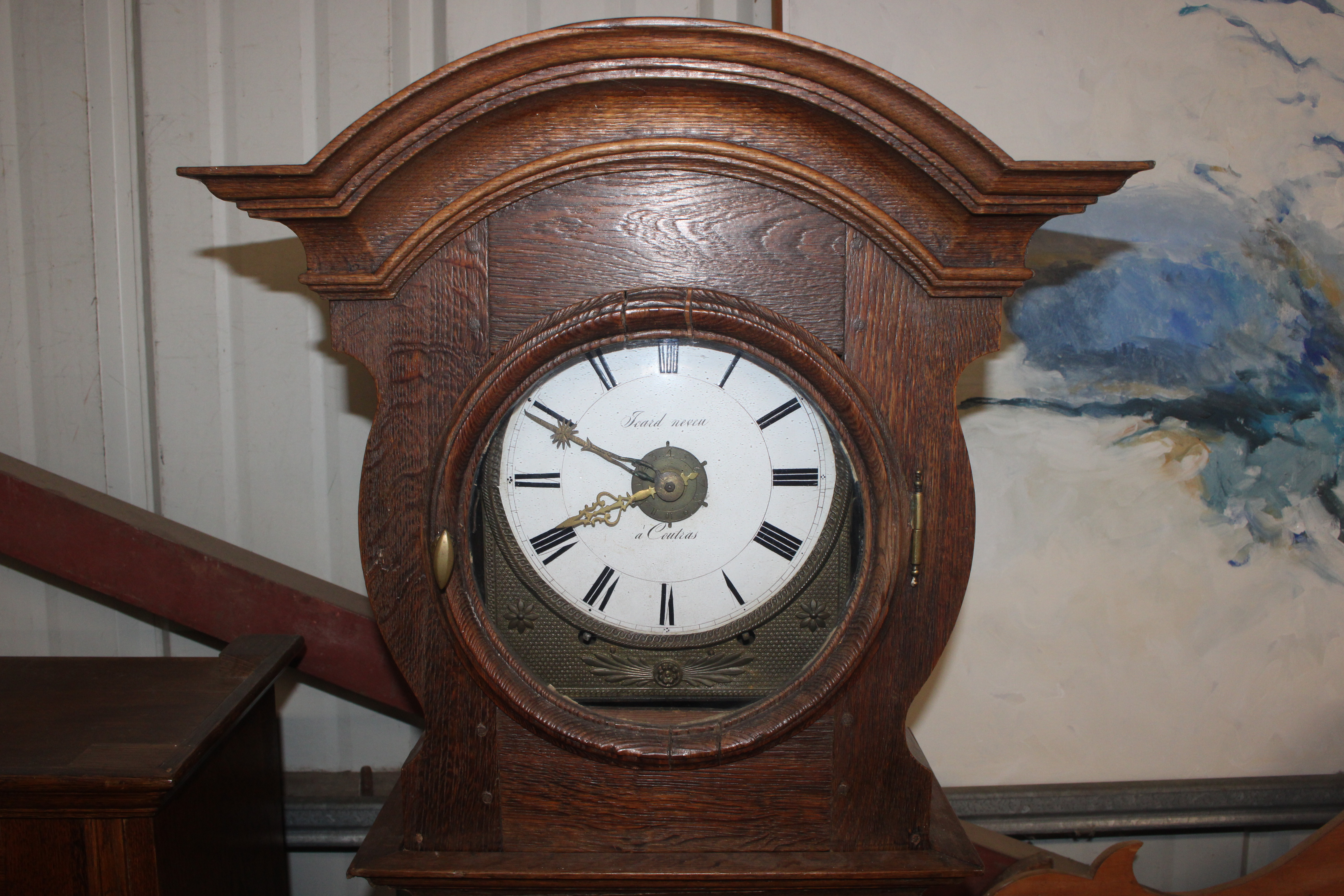 A tall French oak long case clock having circular