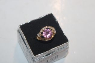 A dress ring set with pink stone