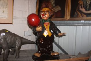 A painted wooden clown ornament, 58cm high