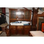 An oak dresser with glazed upper section