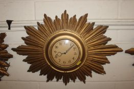 A gilt sunburst wall clock