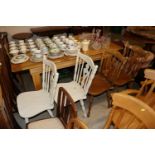 A pair of elm seated kitchen stick back chairs and