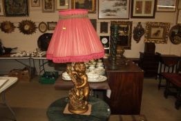 A gilt cherub table lamp of large proportions with