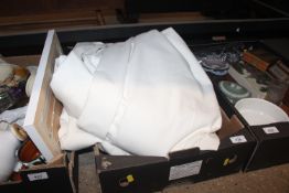 A box containing a pair of white curtains with pin