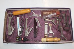 A box of corkscrews and vintage bottle openers