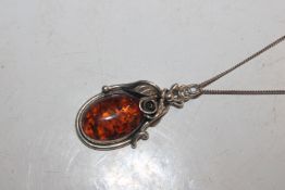 A Sterling silver and amber necklace with rose det